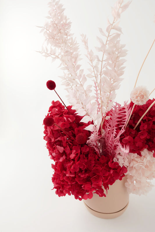 Red and pink preserved everlasting flower arrangement. 