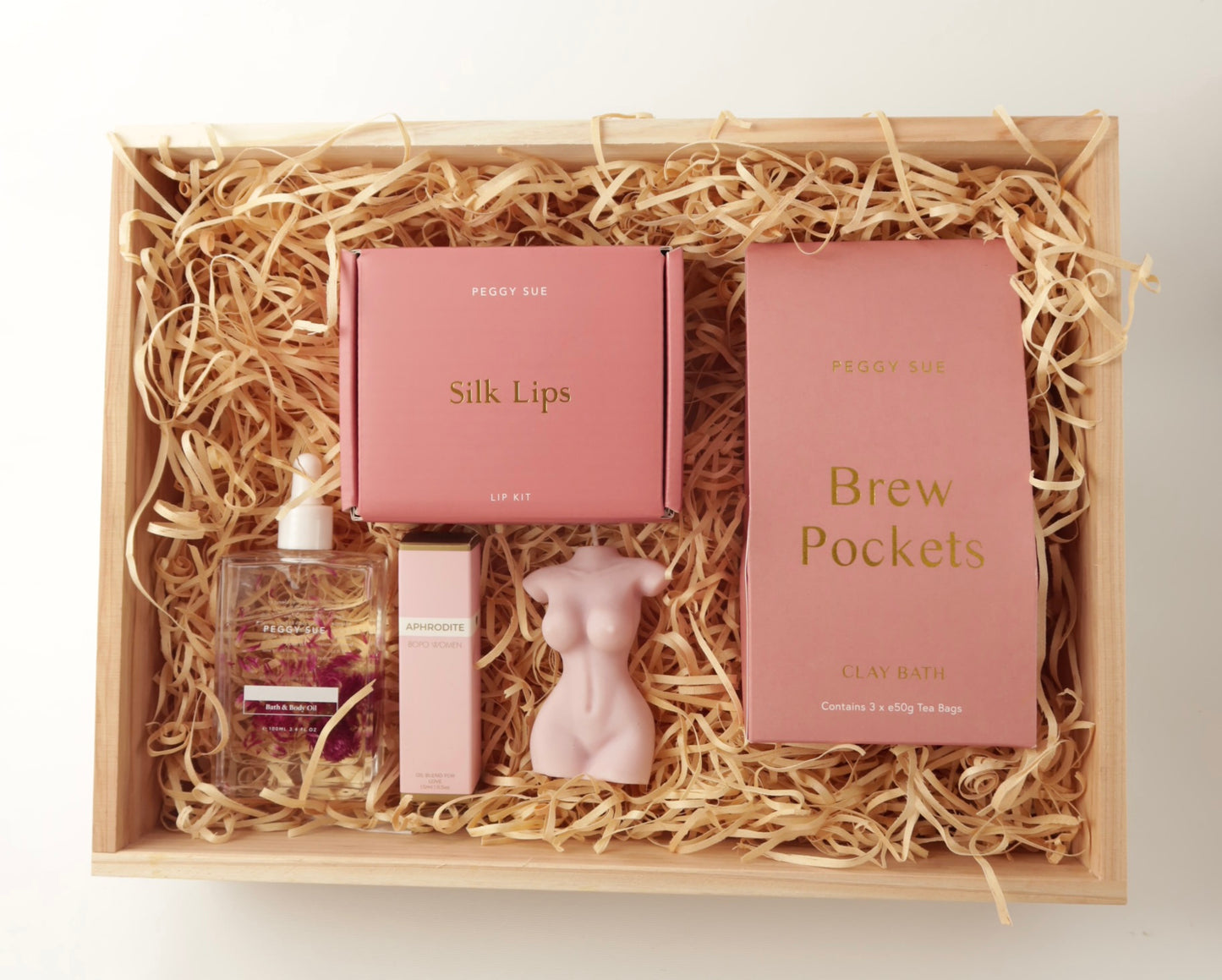 The 'Glow' Gift box. This bath and body hamper includes Bath brew pockets and a silk ip care kit by Peggy Sue. A crystal perfume roller and Spring of seed body oil by Bopo Women and a handmade soy wax lady figure candle. 