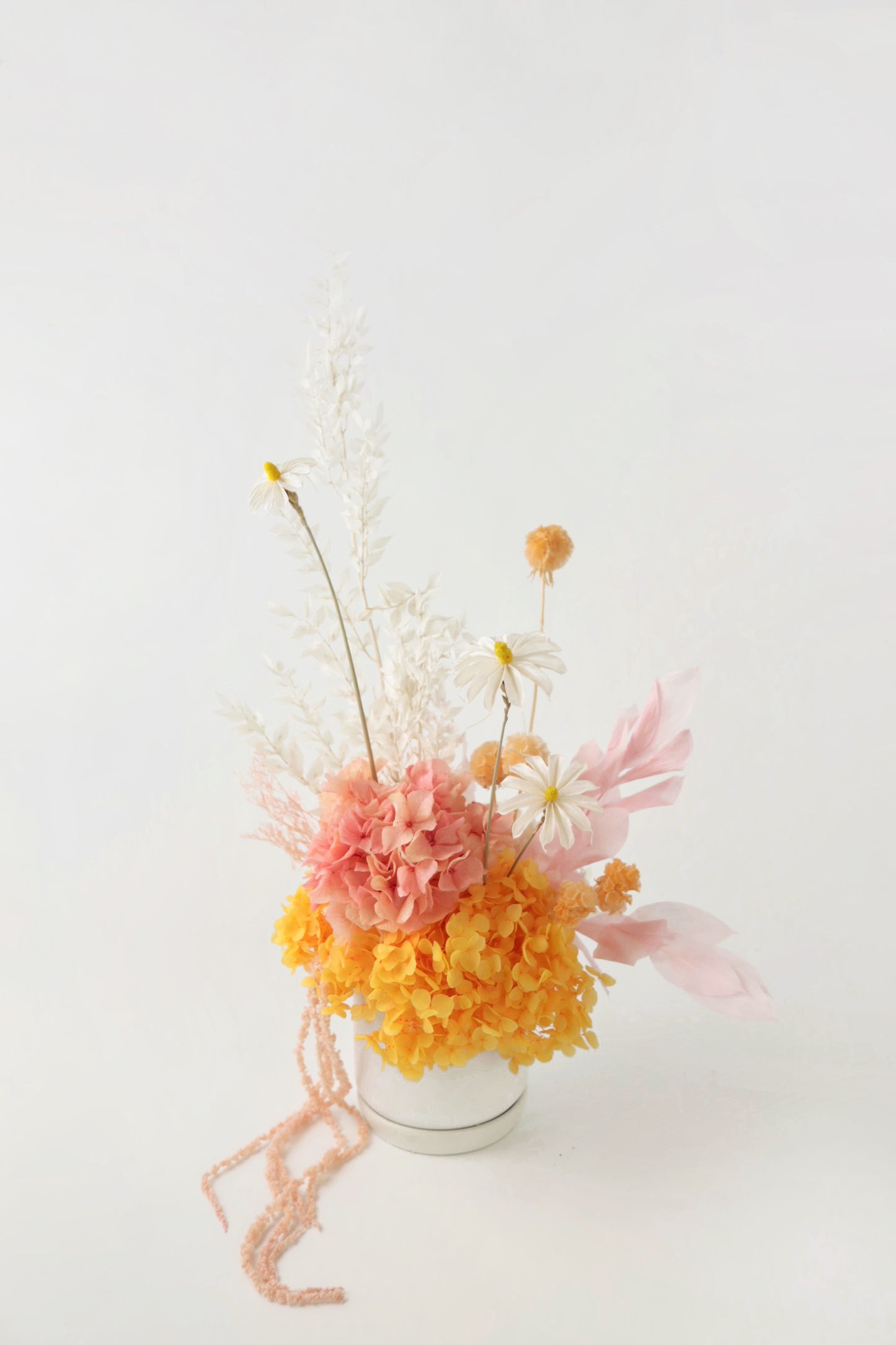 Orange, pink and white preserved everlasting flower arrangement. 