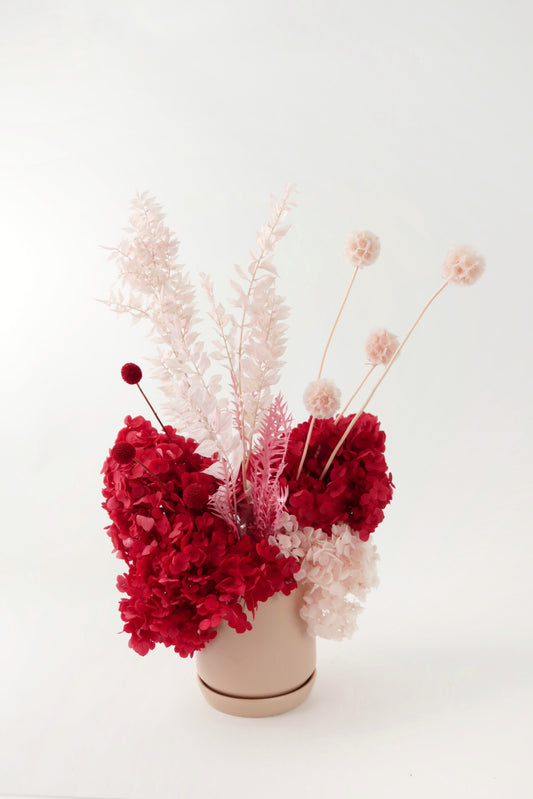 Red and pink preserved everlasting flower arrangement. 
