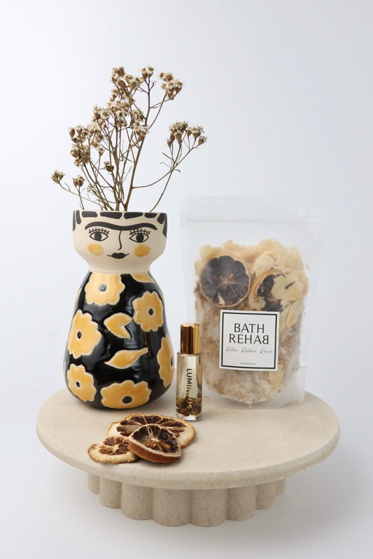 The 'Marigold' Gift Hamper including a citrus blend of bath soak by Bath Rehab, Luminious crystal perfume roller by Bopo Women and a handmade ceramic face vase by Jones and Co.