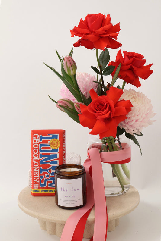 The Fun Mum Flower & Gift Hamper, including a fresh flower vase arrangement, premium chocolate bar & hand poured soy wax candle.