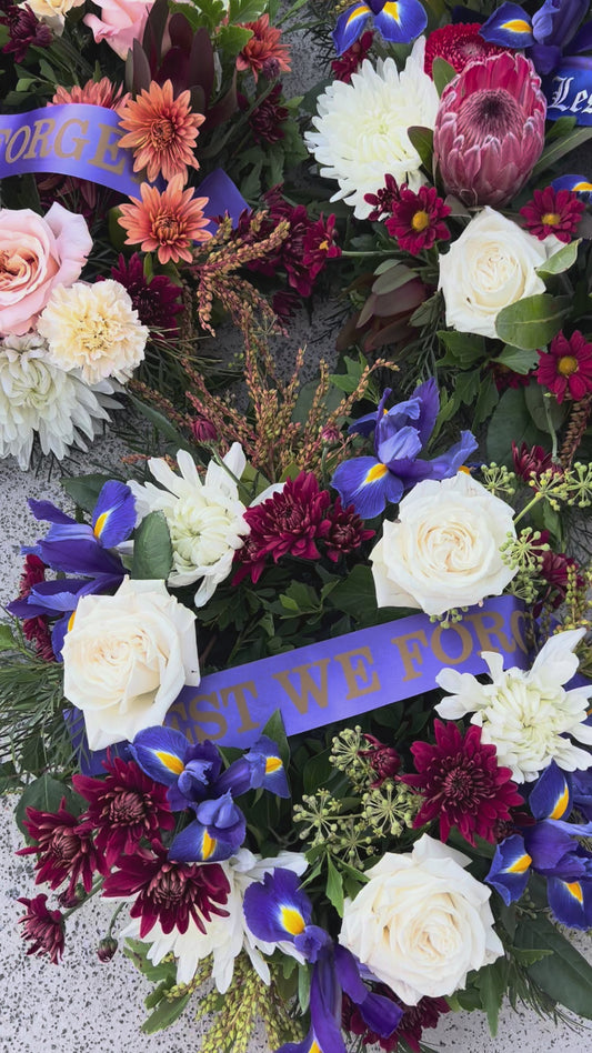 Wreath flower arrangement for sympathy and tribute occasions. With Lest We Forget ribbon