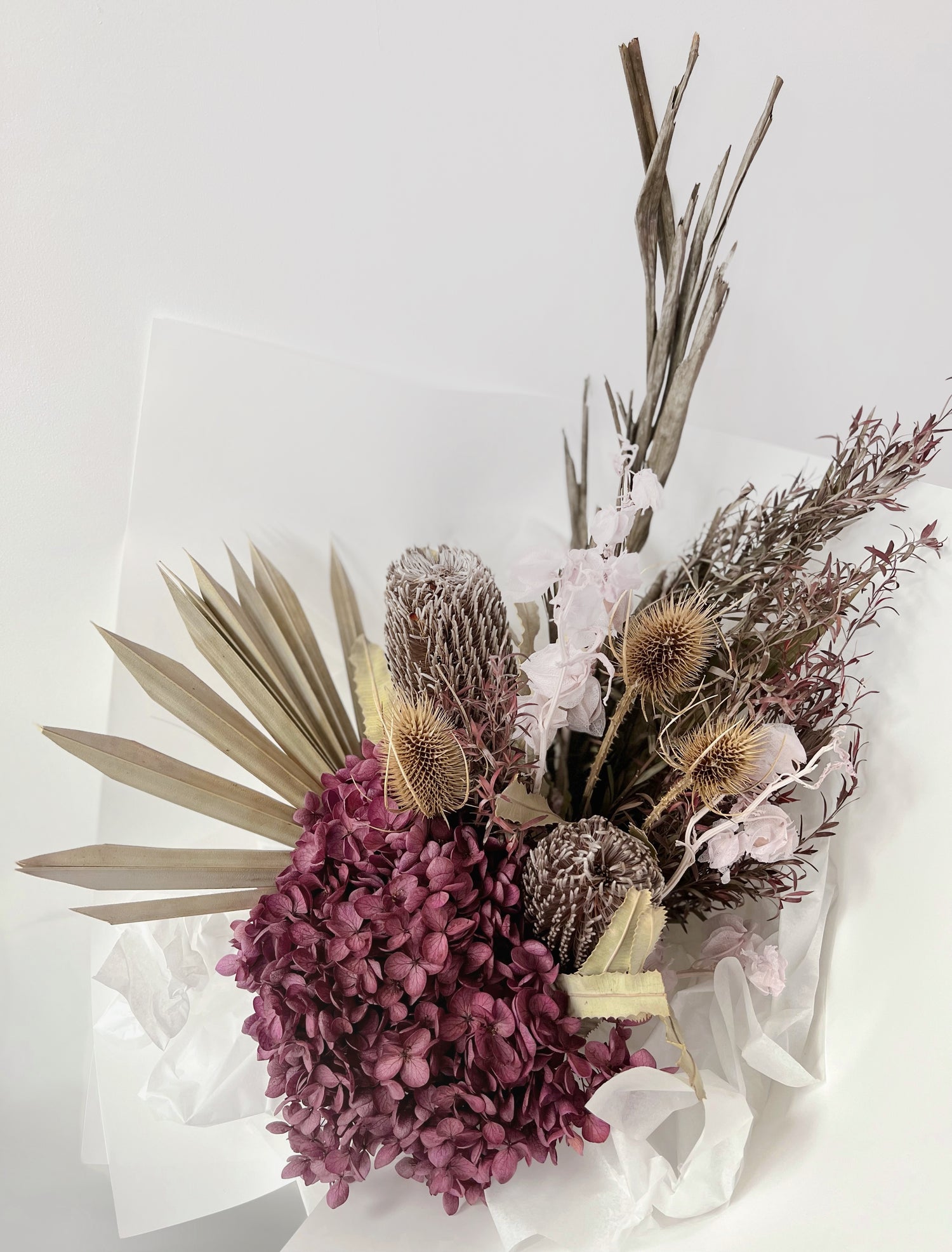 An earthy everlasting florist bouquet featuring preserved and dried flowers in brown, raw and plum colour palette. Same day delivery Hobart Tasmania