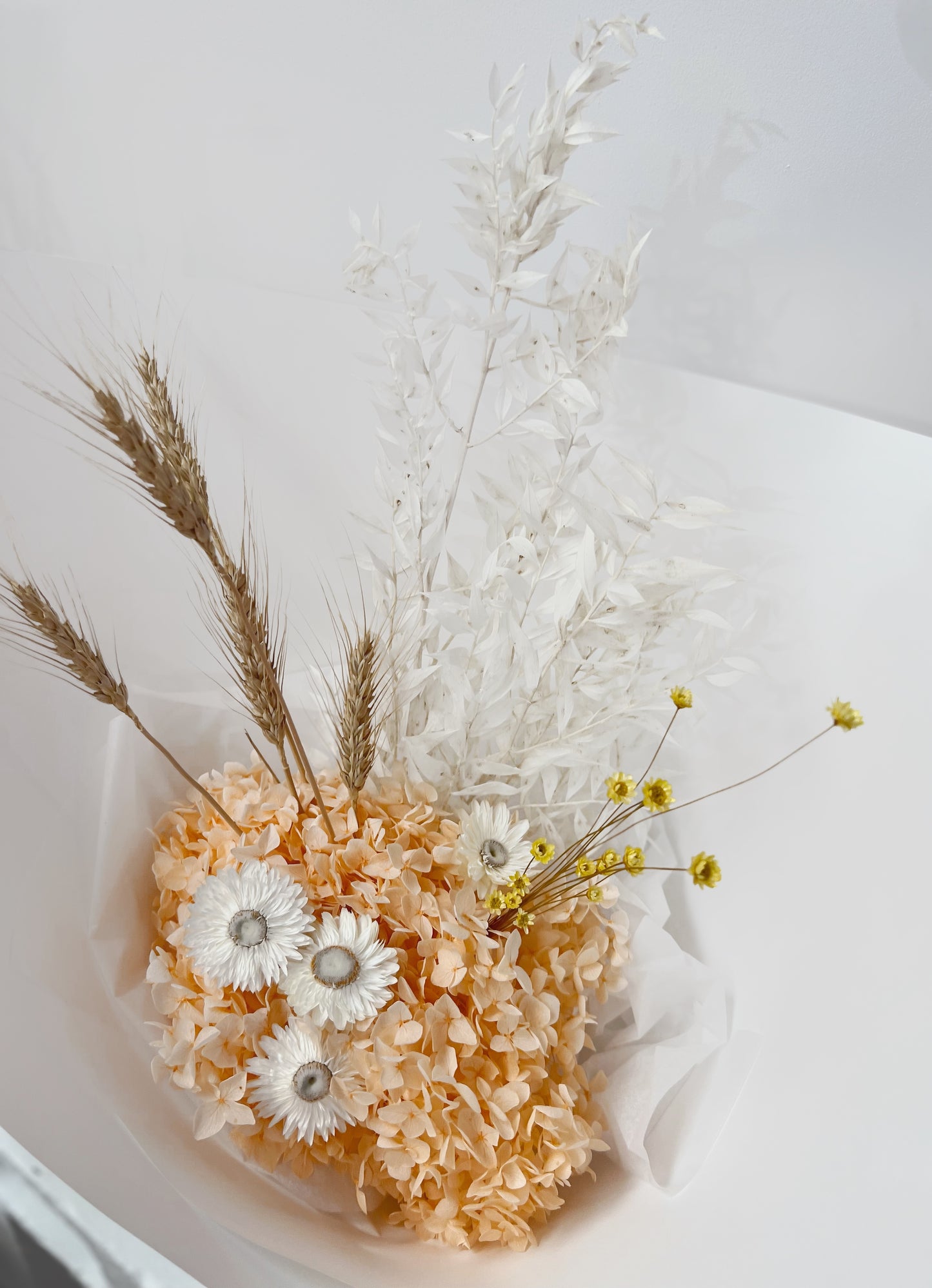 A colourful everlasting florist bouquet featuring preserved and dried flowers in white, peach, yellow and nude colour palette. Same day delivery Hobart Tasmania