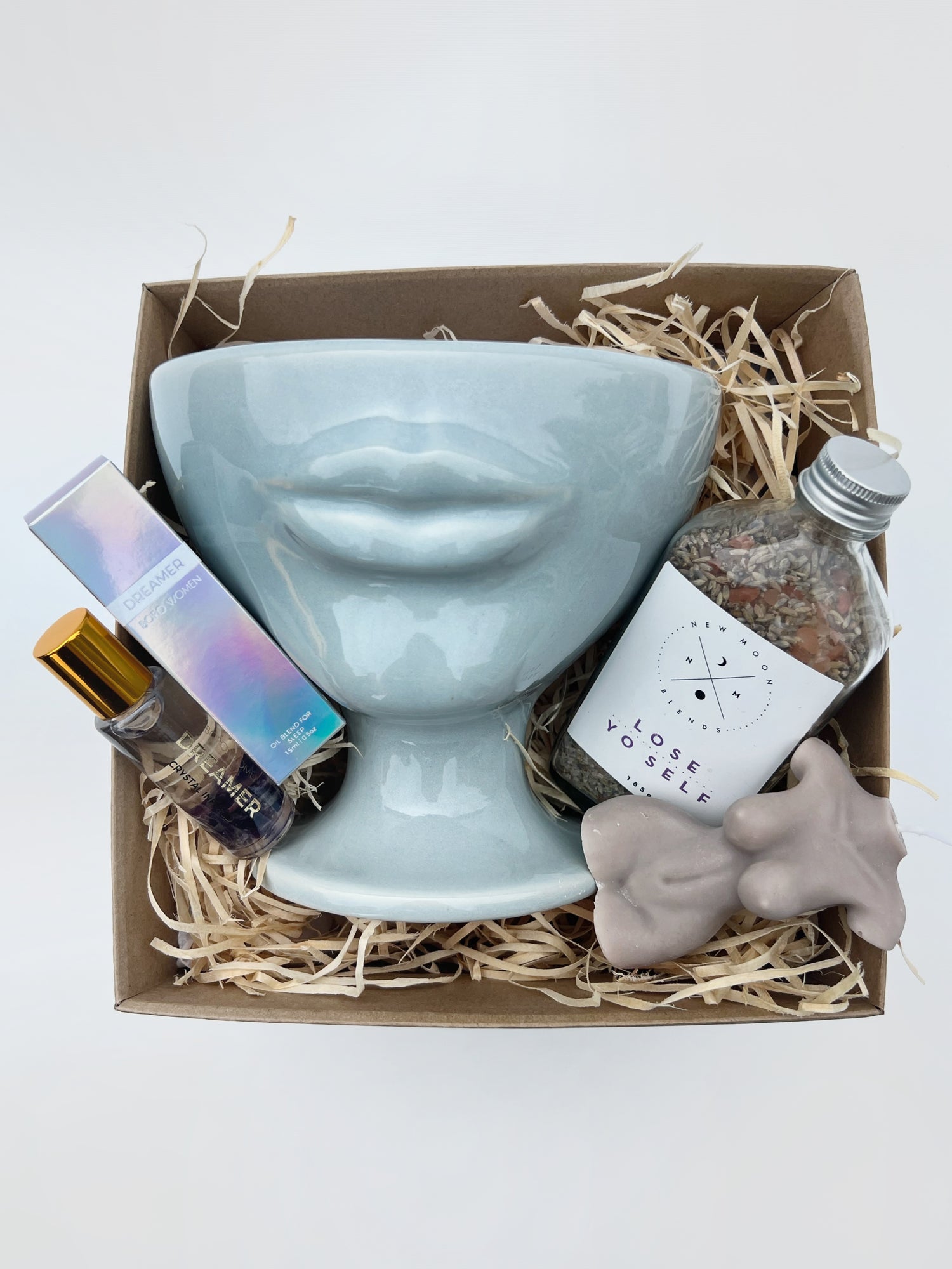 A fun and playful homeware, bath & body gift box. Including pale blue handmade ceramic lip vase, bath soaks, crystal perfume roller & lady soy wax candle. Gift wrapped and presented in our signature wrapping & branding.